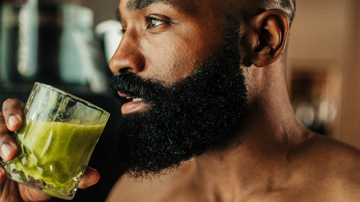 A man drinking vegetable juice